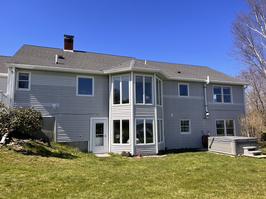 Finished white gutter system showing downspout and elbows